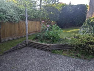 Old wood tie wall to be replaces with Allan Block