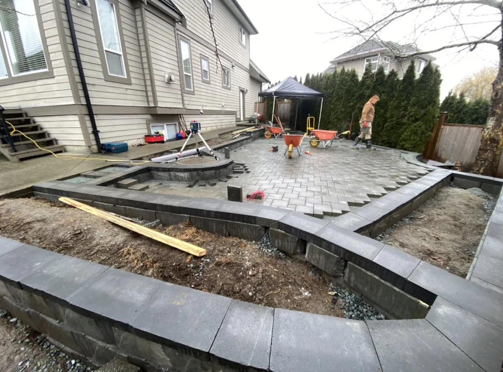 Atkinson Landscaping building a patio area bordered by Allan Block